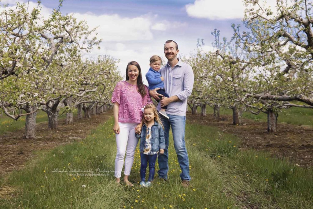 family of four in an apple orchard, spring photo session, CT family photographer