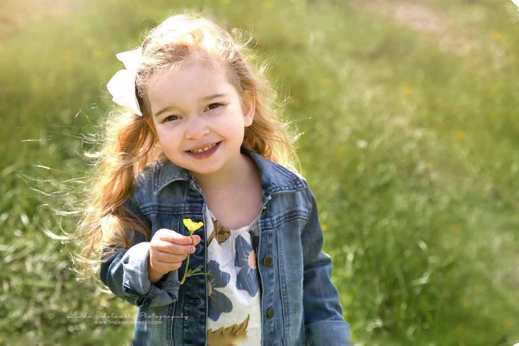 pretty little girl with blonde hair holding flowers, Family photo session, Old Saybrook, CT photographer