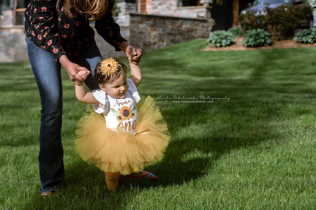 little baby in yellow tutu, walking on the grass, One year old baby pictures, Branford CT Photographer