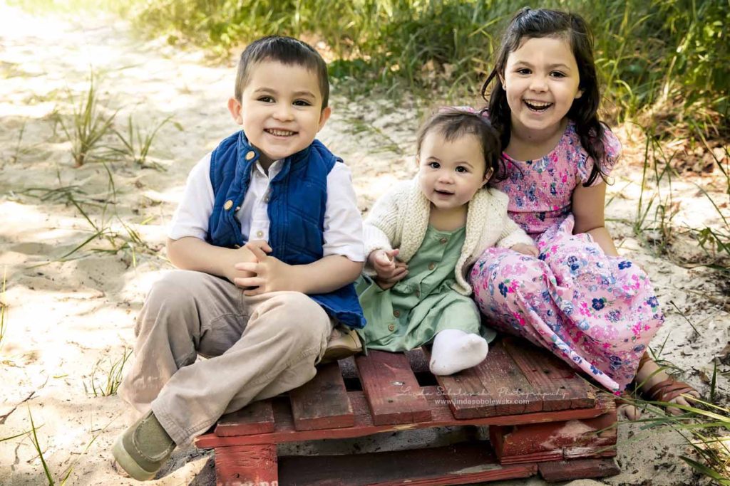 three children sitting on a red crate at the beach, Family Photo Session at the beach, Connecticut Child Photographer