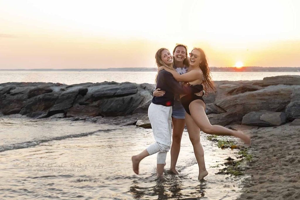 three girls hugging each other at the beach, Connecticut Family Photographer