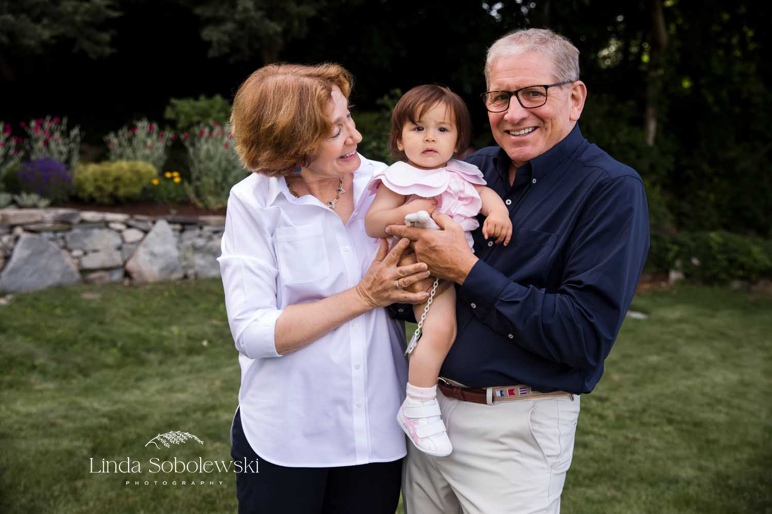 grandparents holding their granddaughter, Mystic CT Photographer