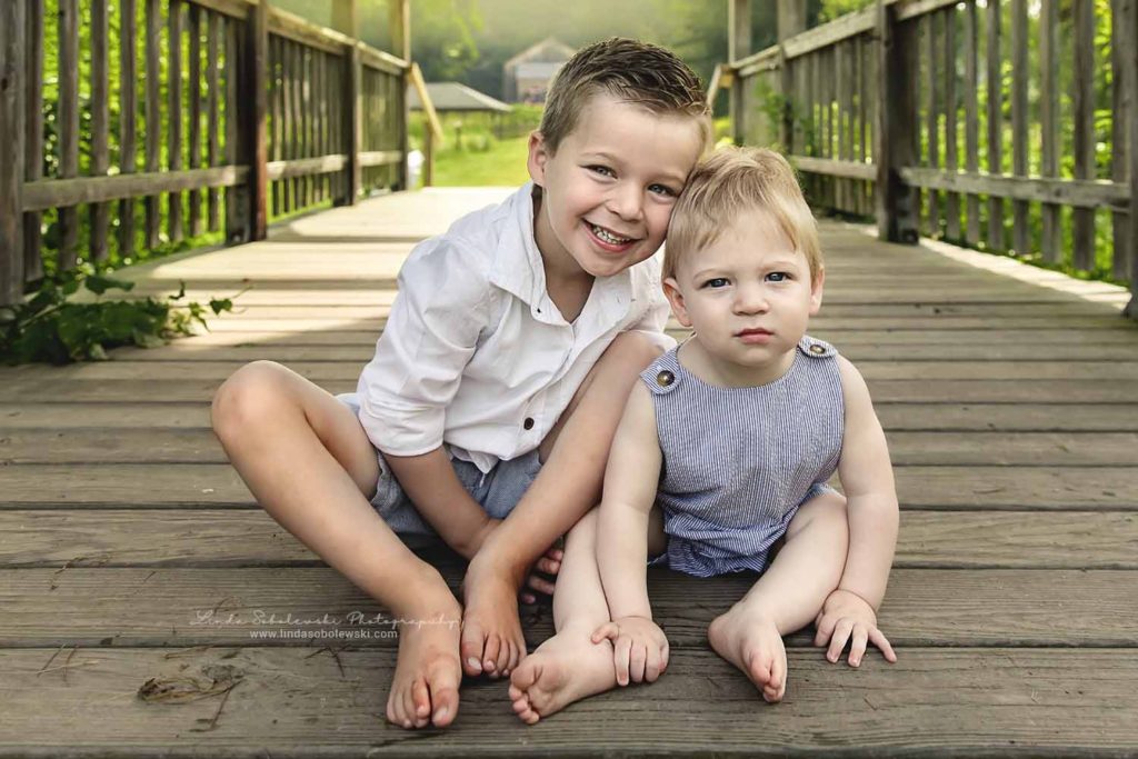 two little boys sitting on a bridge, Connecticut Family Photographer