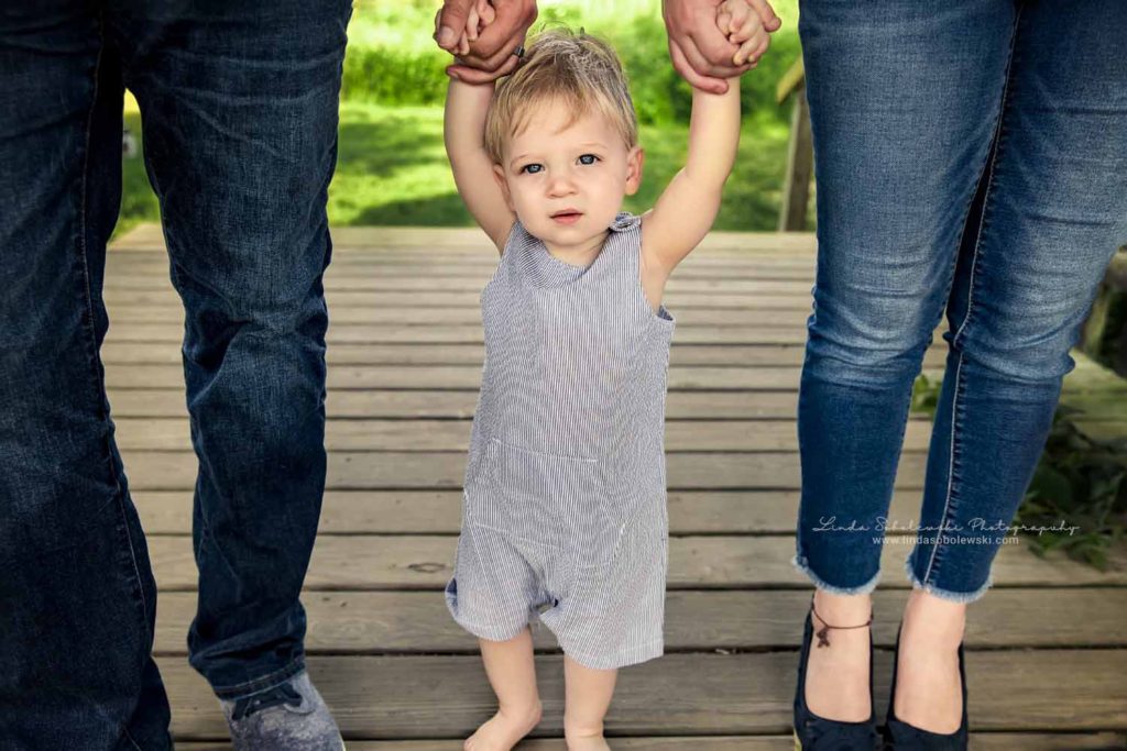 parents holding the hand of their one year old boy, Guilford, CT Family Photographer