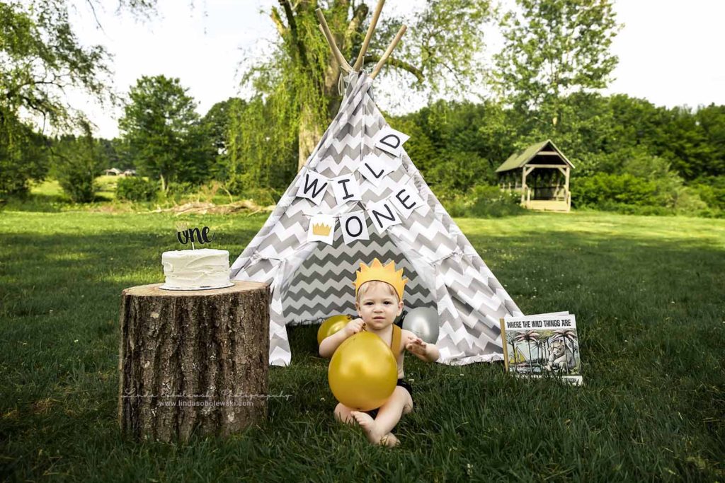 little boy sitting next to a teepee at his one year old photo session, Connecticut Best Family Photographer
