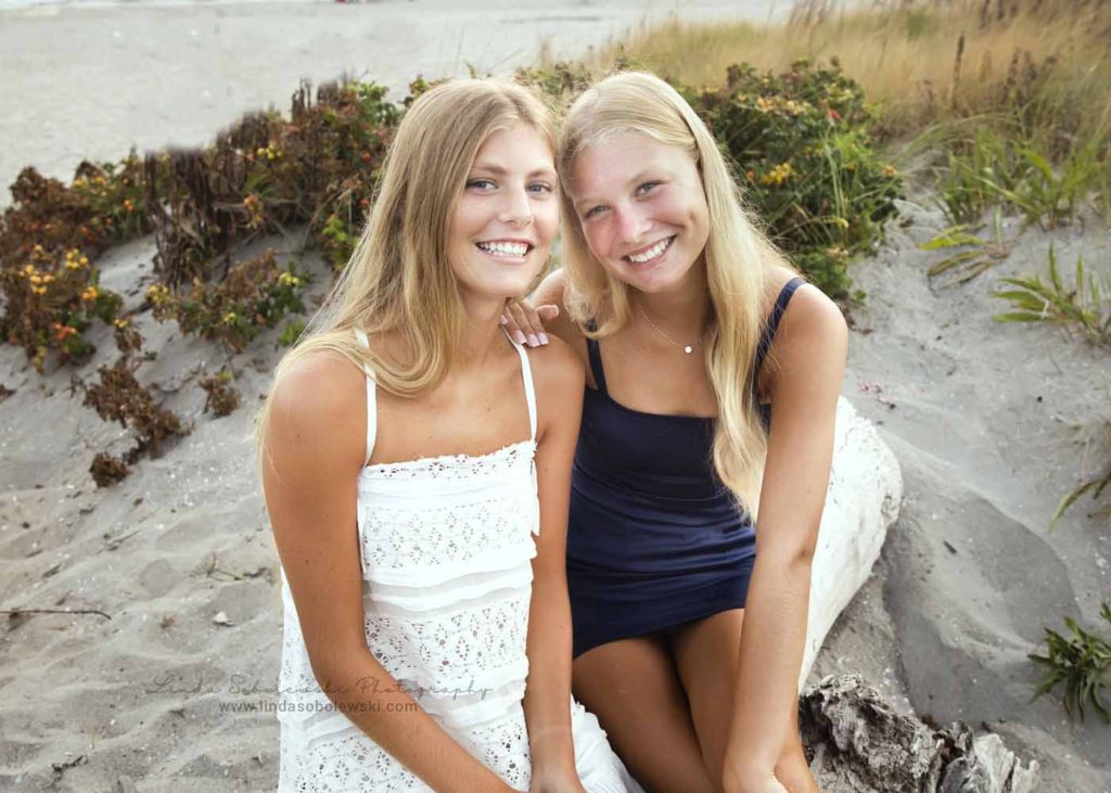 two blonde girls sitting at the beach, Guilford, CT family photographer
