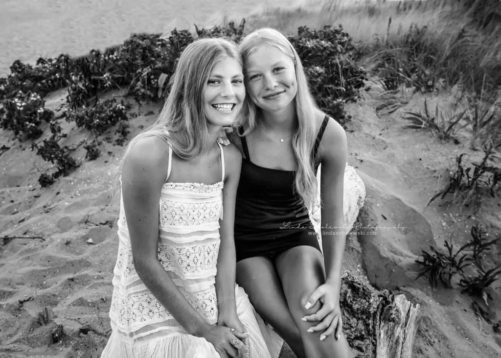 two blonde girls sitting at the beach, Guilford, CT family photographer