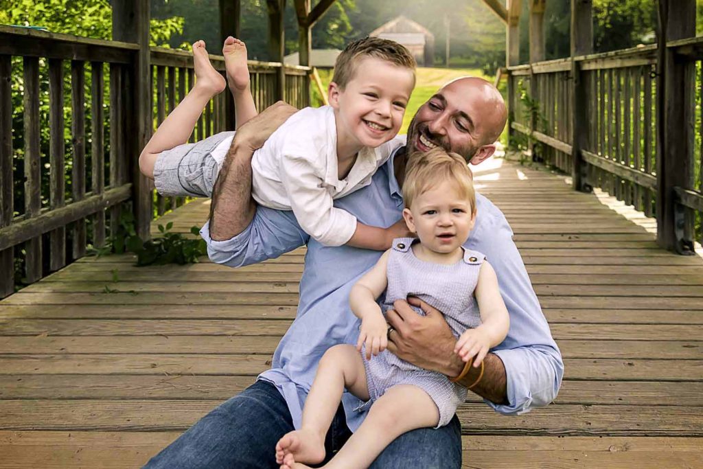 dad holding his toddler son over his shoulder, Looking at photos creates a mood boost, CT Best family photographer