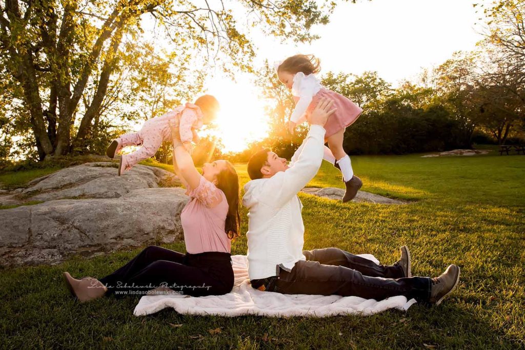 family of four playing together in the sunset, Branford CT Child and family photography session