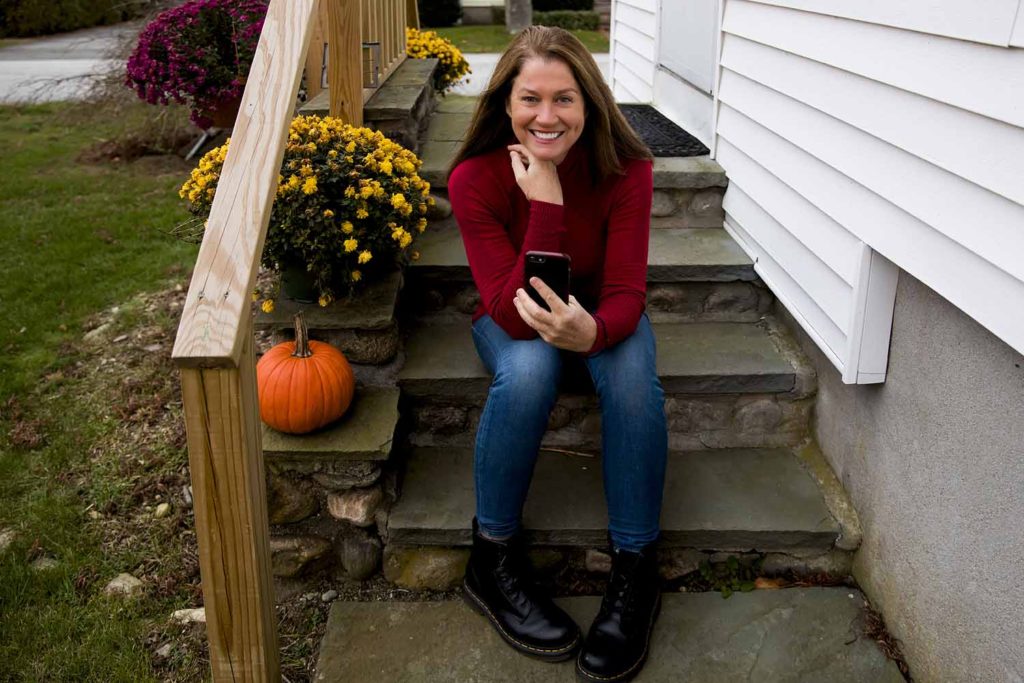 woman in red sweater sitting on a porch, November and December personal project for Old Saybrook, CT photographer