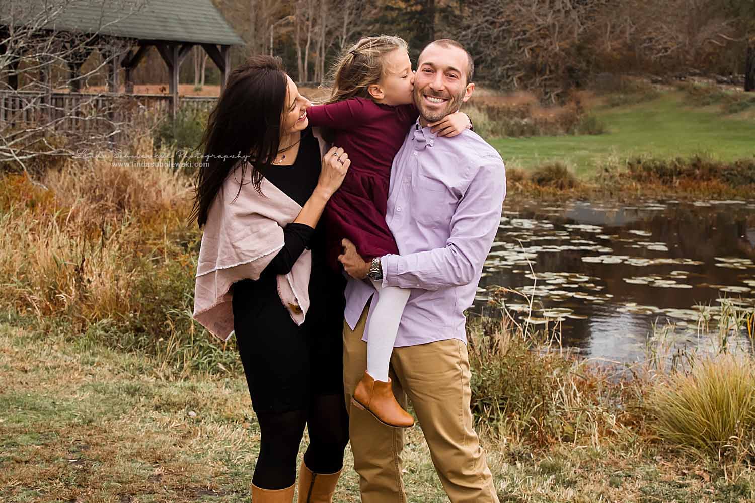 mom and dad holding their little girl, Fall Family Session in Madison, CT
