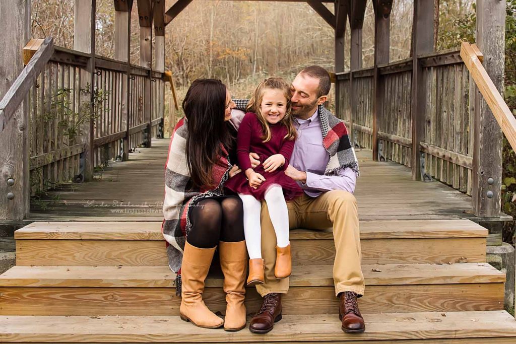 parents hugging with their little girl, CT Fall Family Photo Session