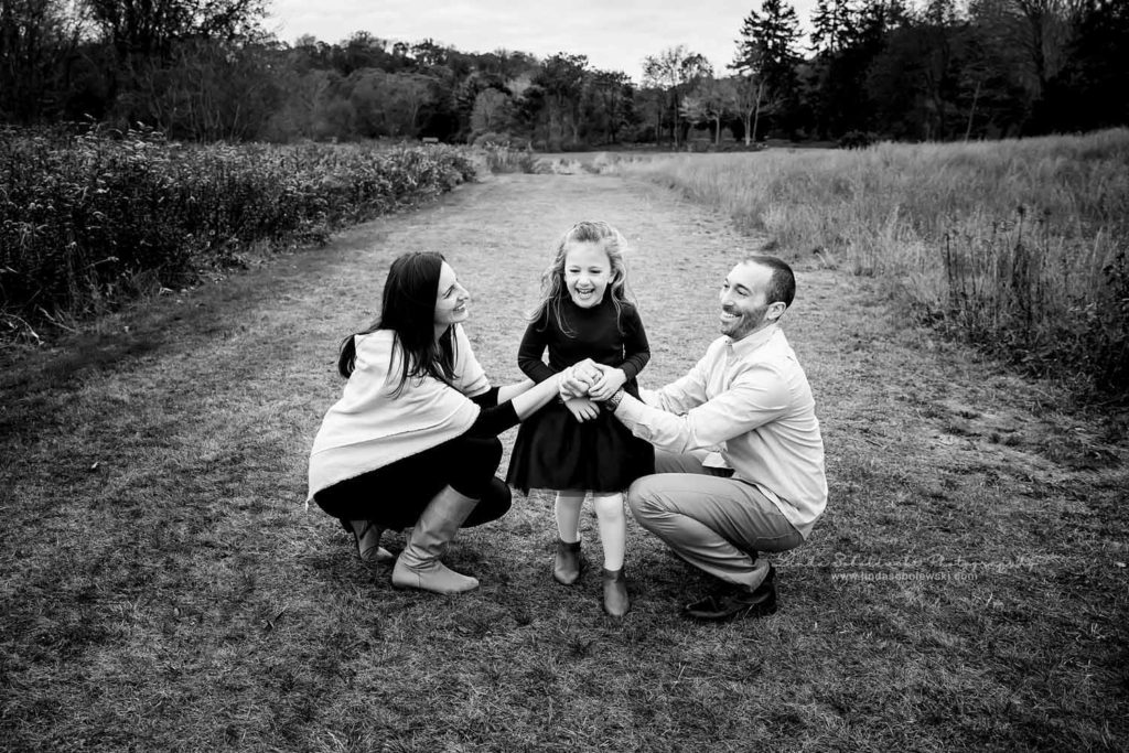 black and white image of parents playing with their little girl, CT Fall Family Photo Session