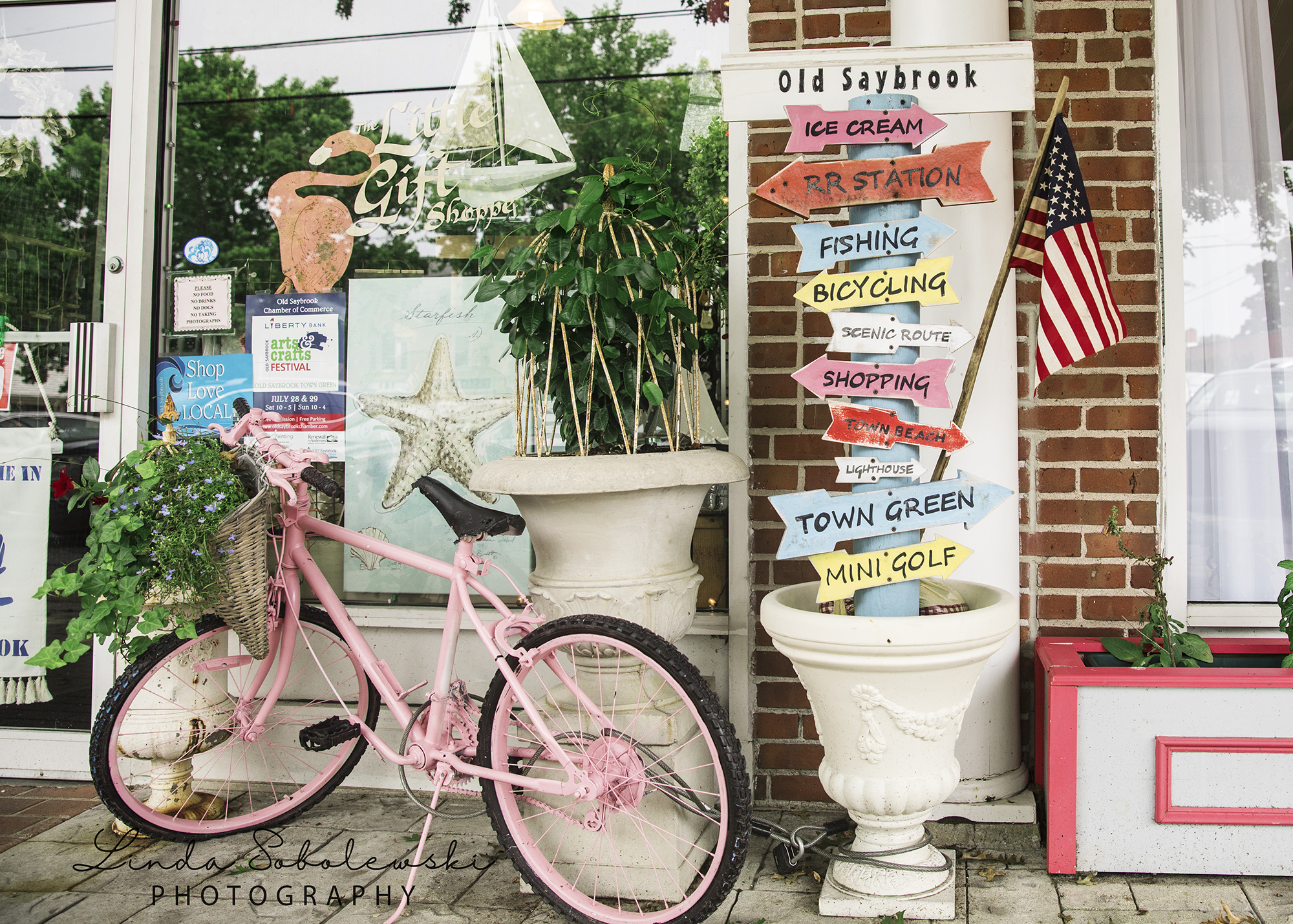 pink bike outside a brick building. Blog post about Things To do while on vacation in Old Saybrook and Westbrook, CT.