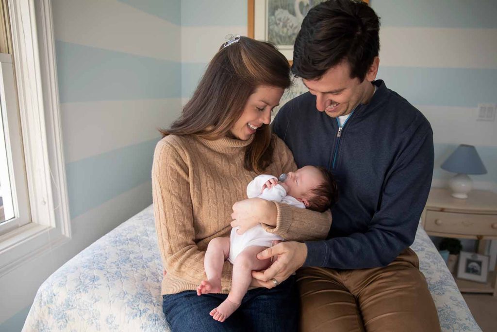 mom and dad holding their new baby girl, Connecticut Lifestyle Newborn Photographer
