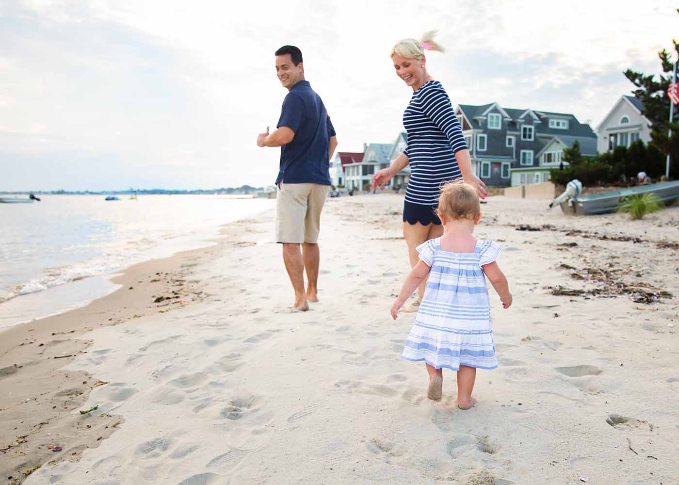 mom, dad and baby girl running on the beach at Water's Edge, Westbrook, CT Family Photographer (things to do while on vacation in Westbrook and Old Saybrook, CT)