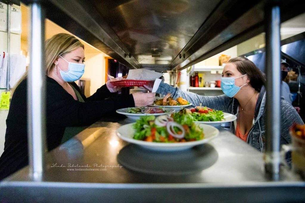 two women working in a kitchen in a restaurant, CT Family Photographer