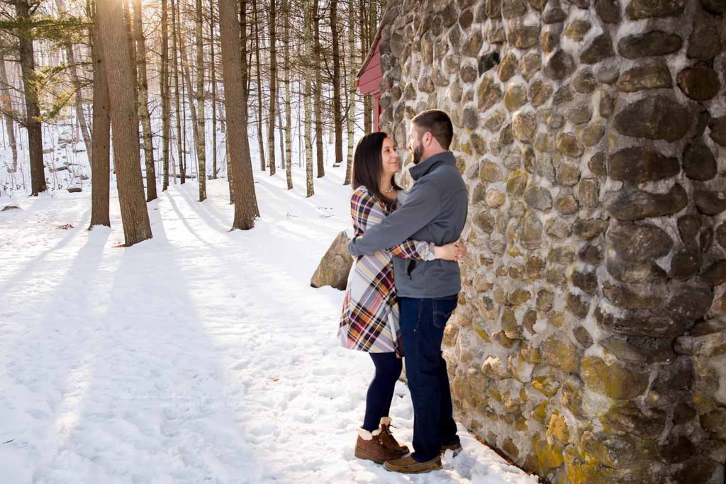 husband and wife with their arms around each other, Session in the Snow, CT Family Photographer