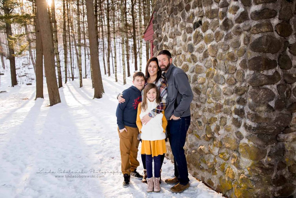 family of four standing together next to a stone wall, , Family Session in the Snow, Old Saybrook Family photographer