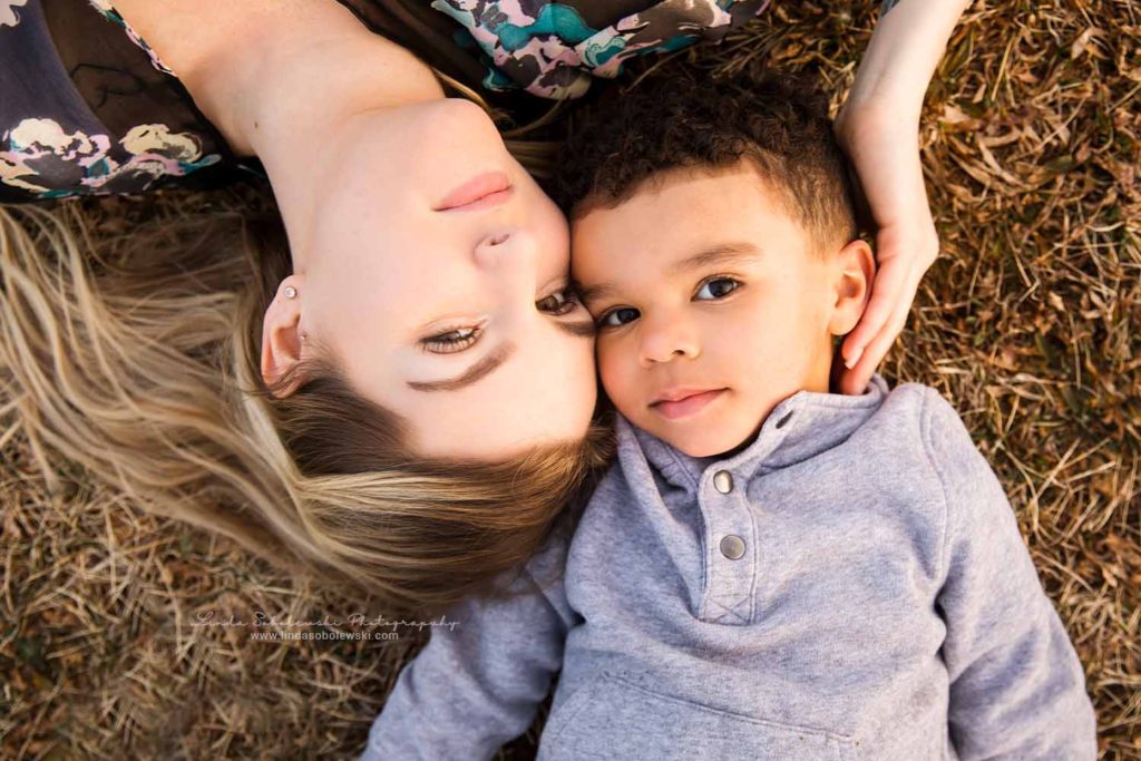 mom and her little boy laying on the ground, Madison, CT Family Photographe