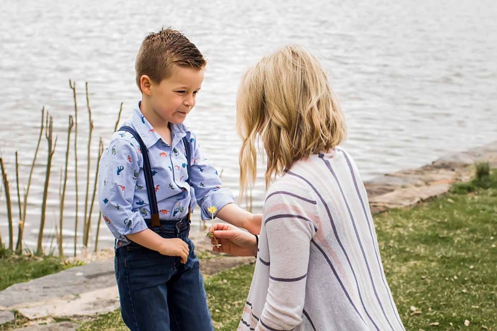 little boy giving his mom flowers, mother's day photos, CT shoreline family photographer