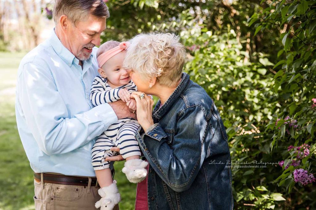 grandparents playing with their grandchild at the park, Chaffinch Island Family Photography Session, Guilford, CT photographer
