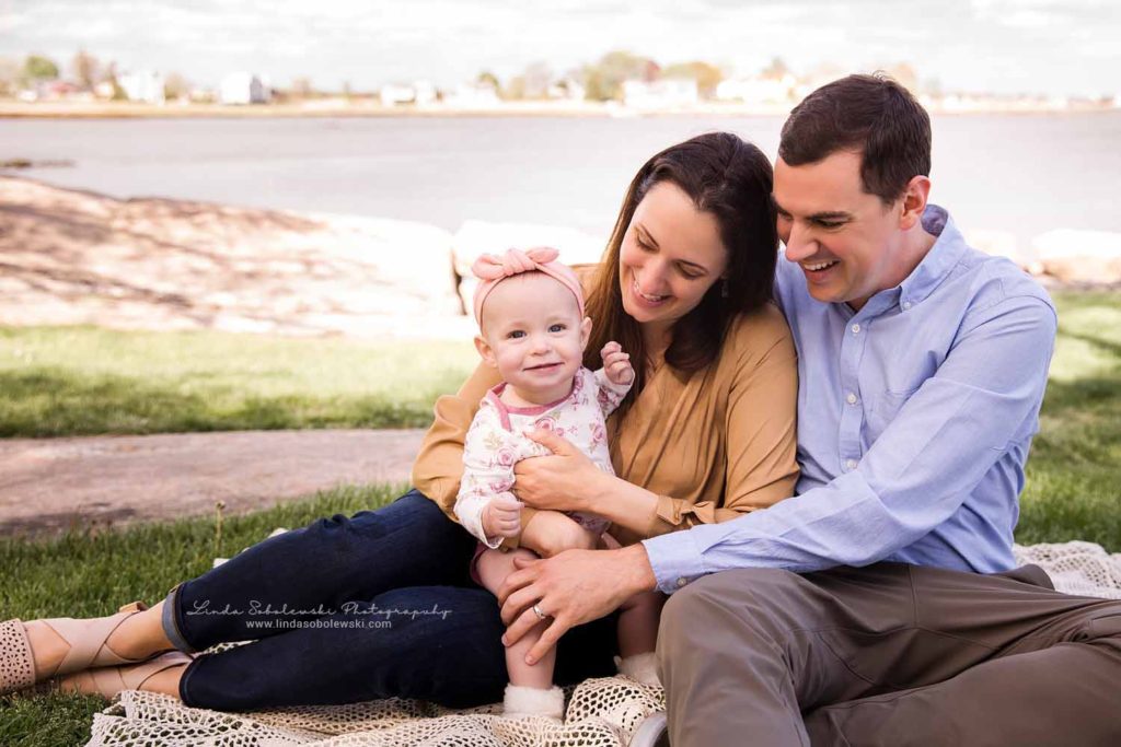 mom and dad holding their new baby girl, Connecticut Lifestyle Newborn Photographer