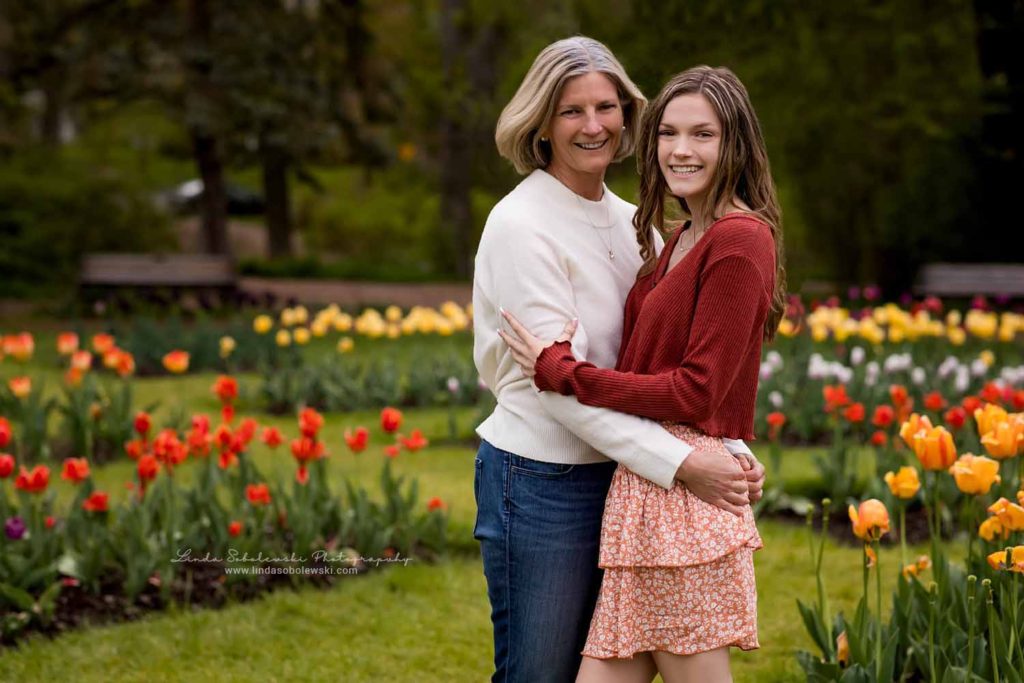 girl in red sweater and her mom standing in the tulip gardens at Elizabeth State Park, Old Saybrook, CT Senior Photographer
