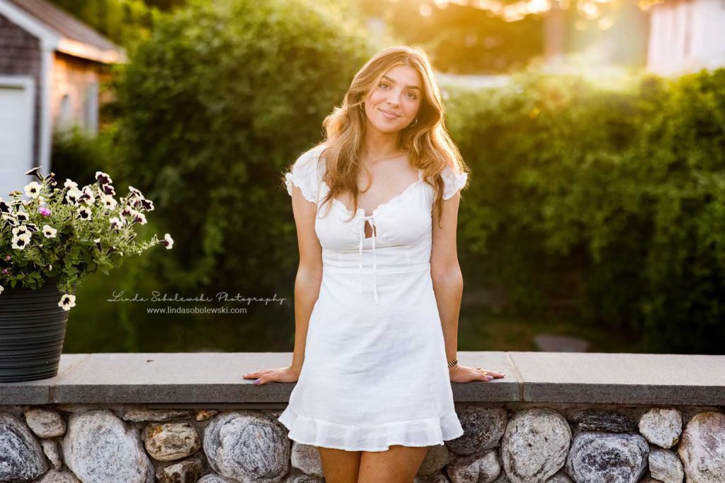 girl with long blonde hair leaning against a wall. CT Shoreline family and senior photographer