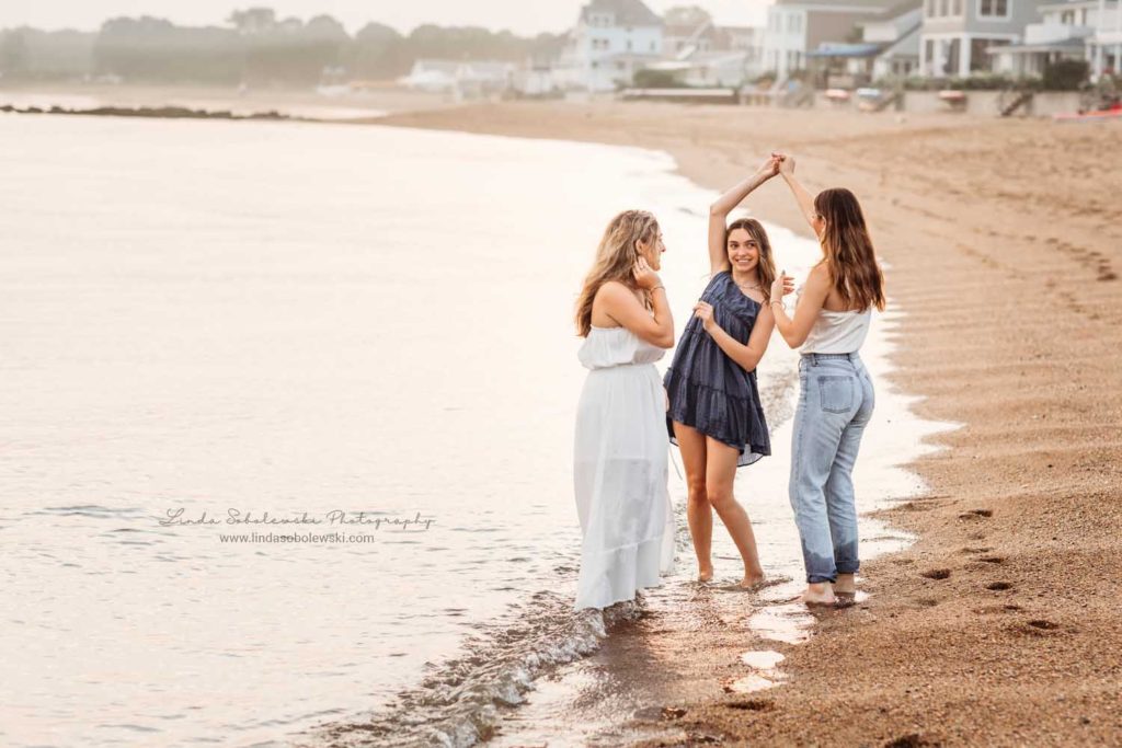 hree teenage sisters walking together t the beach, CT high school senior photo shoot, Madison, CT photography session