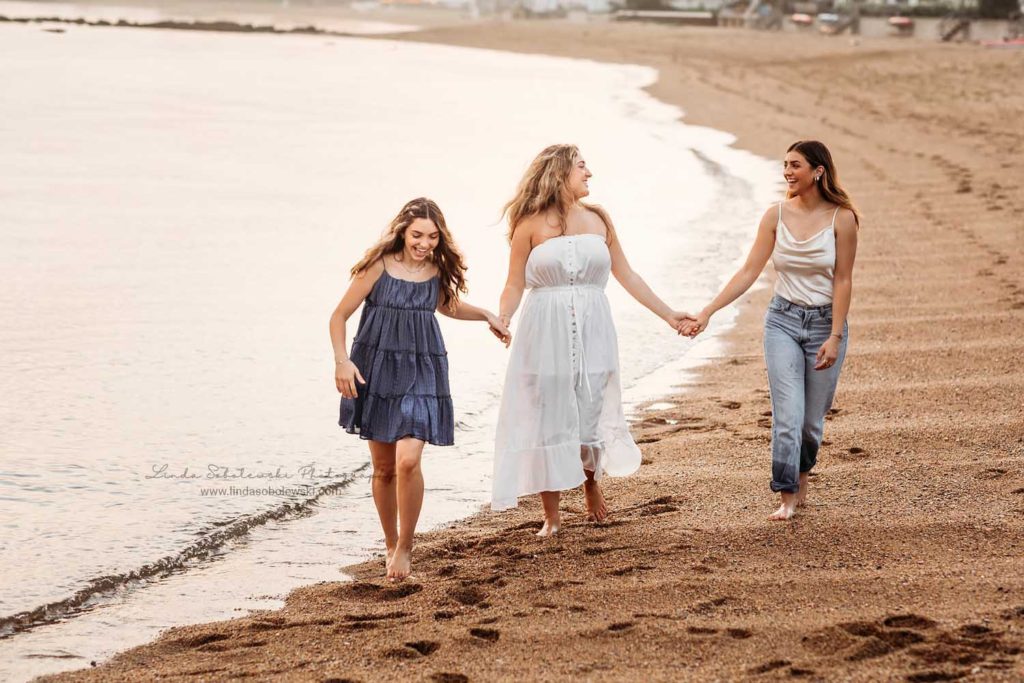 three teenage sisters walking together t the beach, CT high school senior photo shoot, Madison, CT photography session