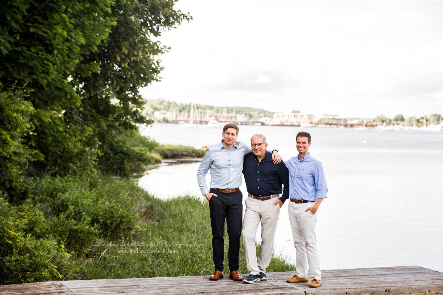 older man and his two sons standing together on a dock, Mystic, CT photographer