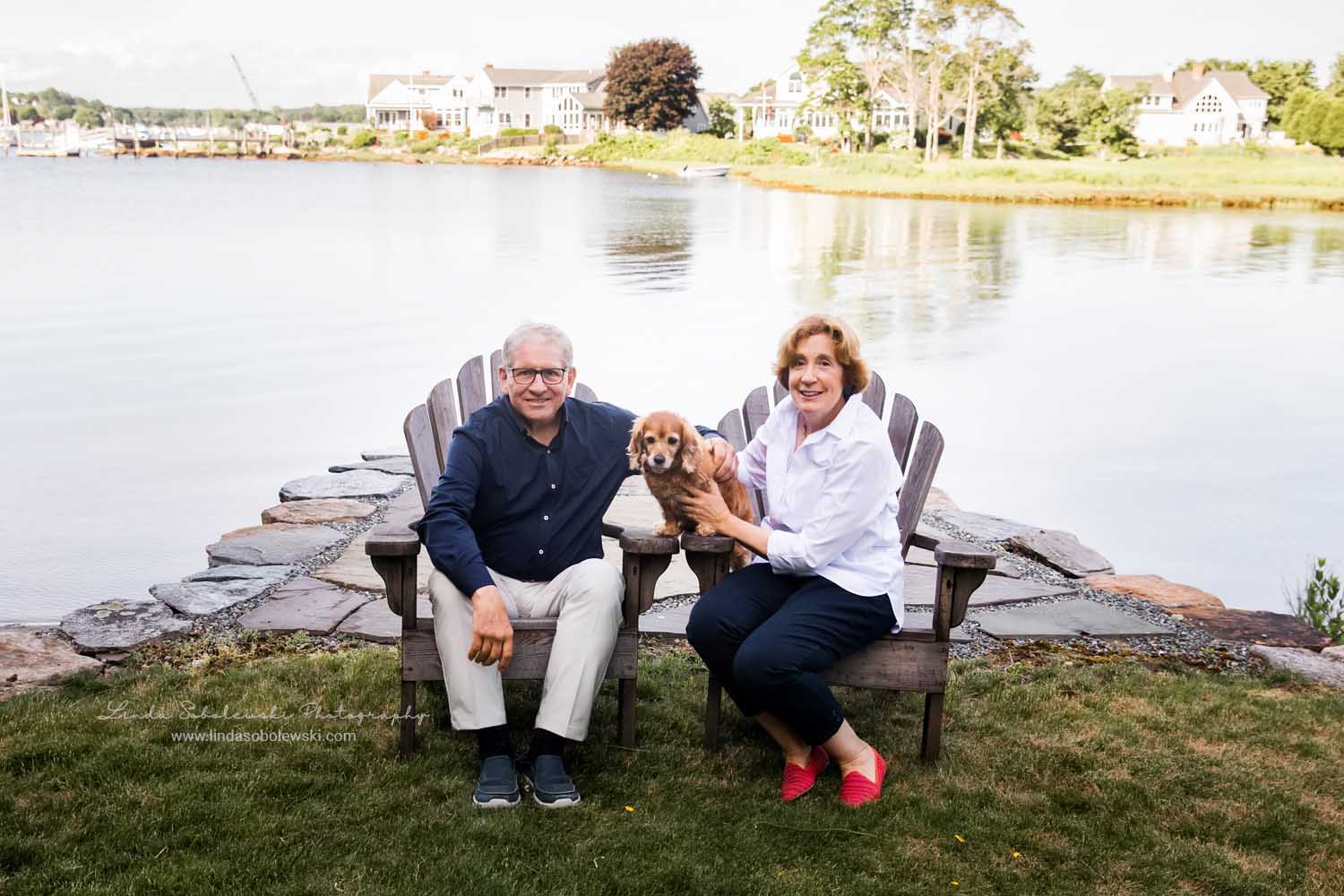 husband and wife sitting on their adirondacks, Big family photo shoot in Mystic, CT