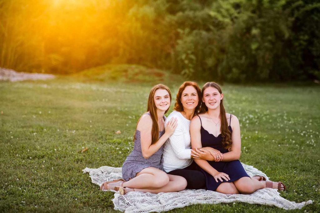 mom sitting with her two teenage daughters, CT shoreline best family photographer