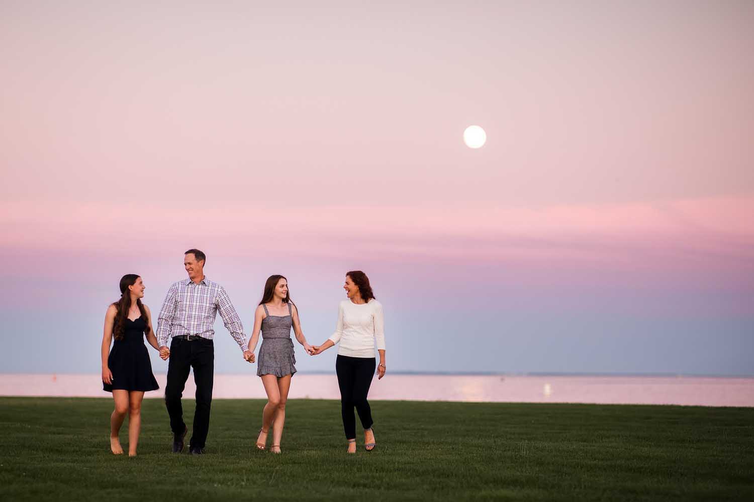 beautiful moon rising behind a family of four, CT Beautiful family photography session