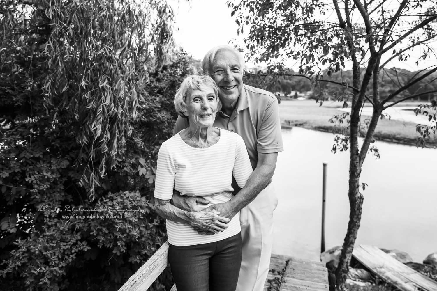 older couple standing together in front of water, Family Reunion photo shoot, Old Saybrook, CT photographer