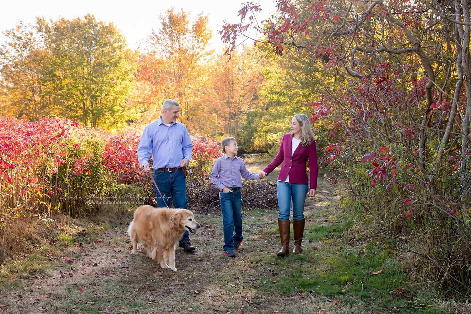 family of three walking their dog at the park, Fall Family Photos, CT shoreline photographer
