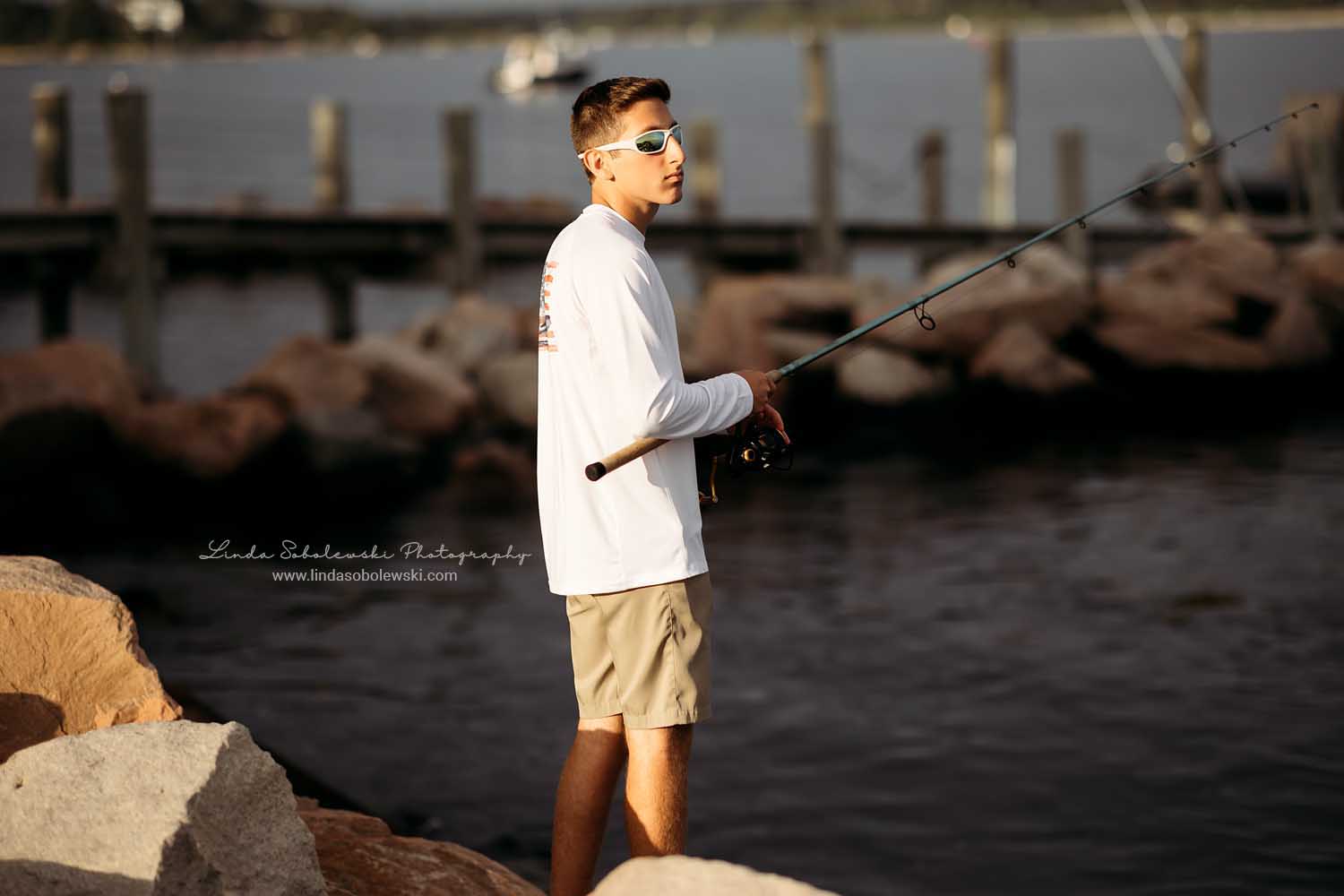 boy fishing in the ocean, Guilford, CT Senior photographer