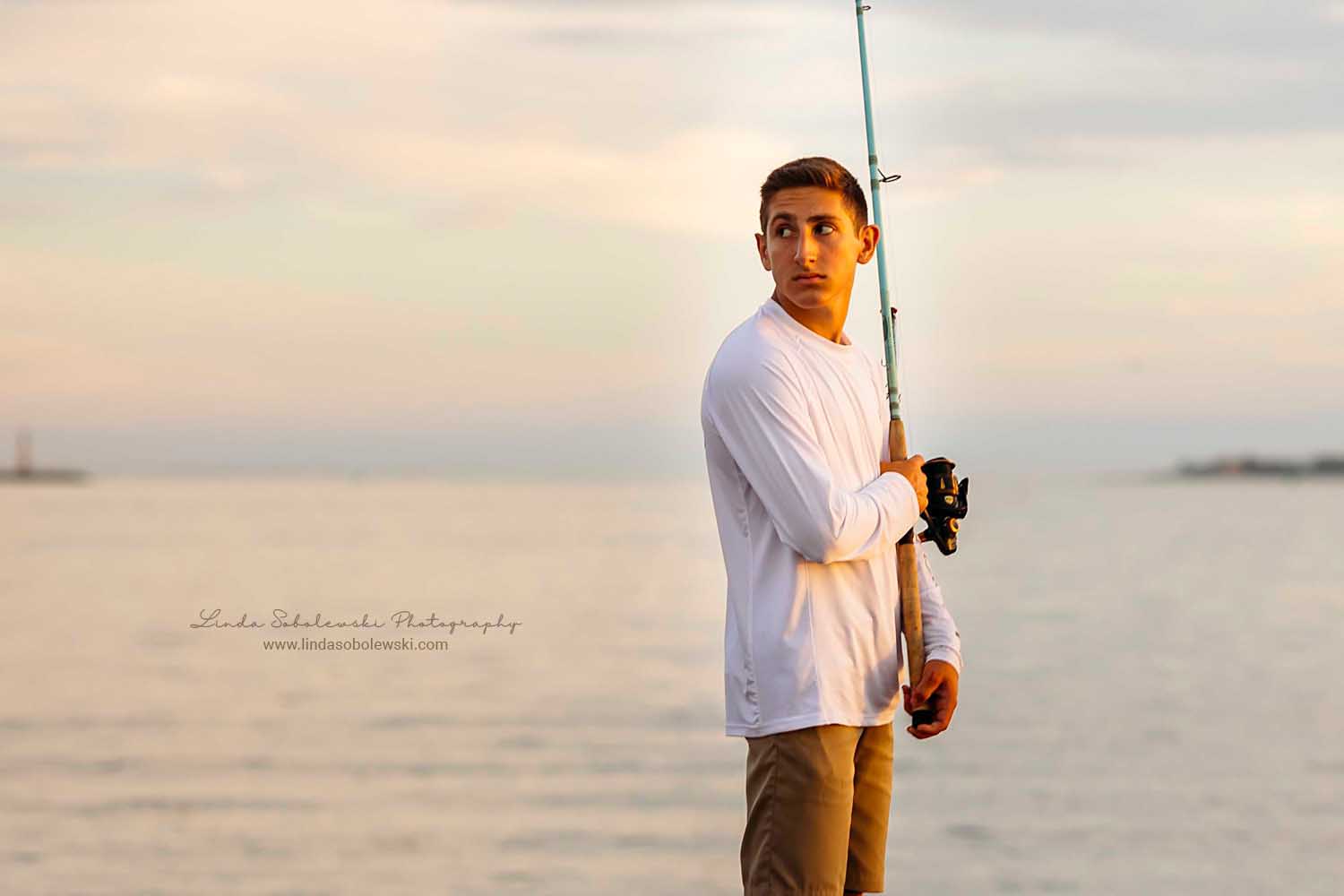 boy fishing in the ocean, CT Shoreline senior boy photographer