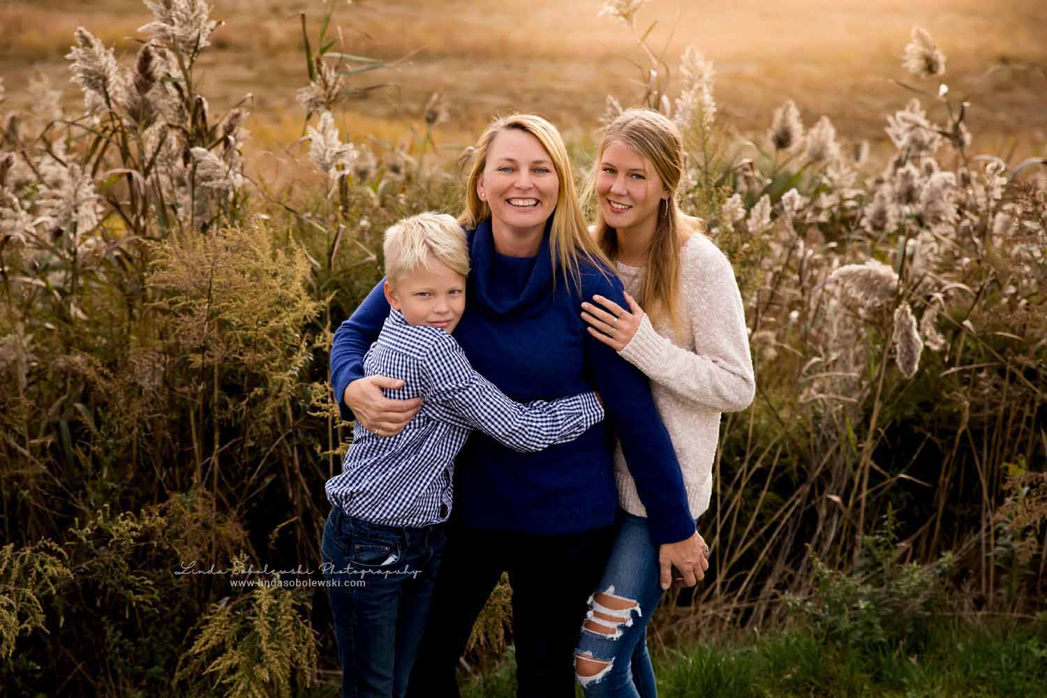 mother and her two children posing for a beautiful family photo. CT Fall photographer