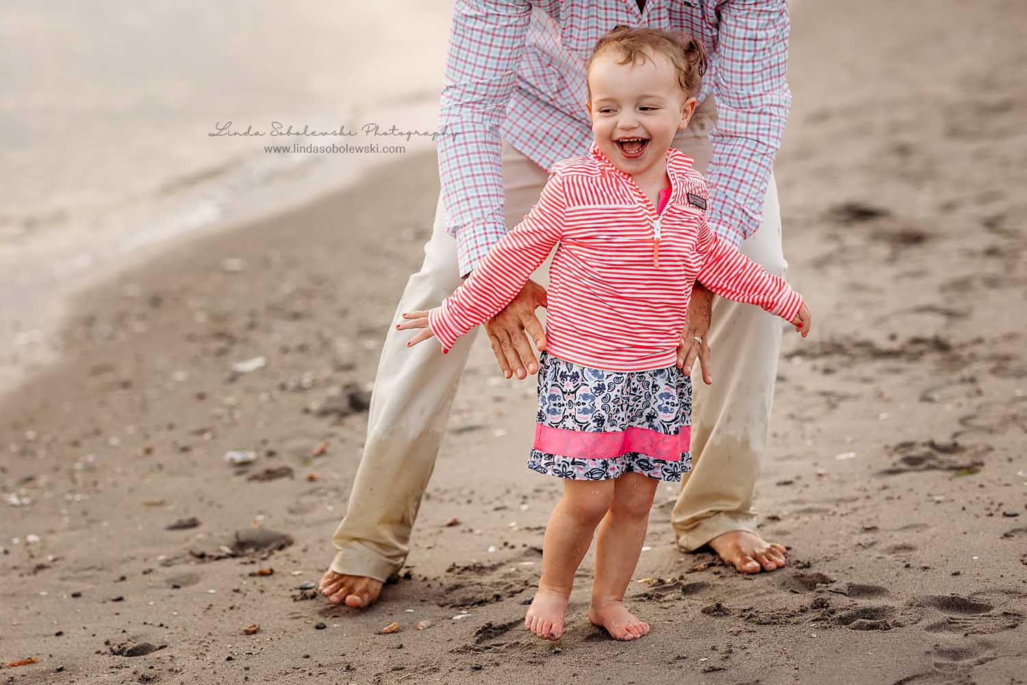 little girl in pink shirt playing in the water, photo session at the beach, CT Shoreline Family photographer