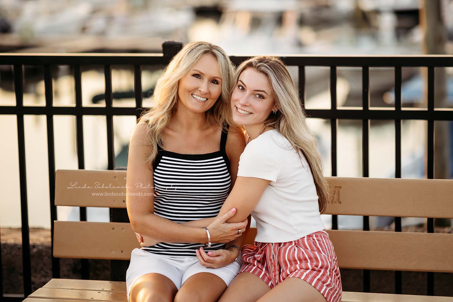 girl and her mom sitting on a bench Guilford Senior Photography Session