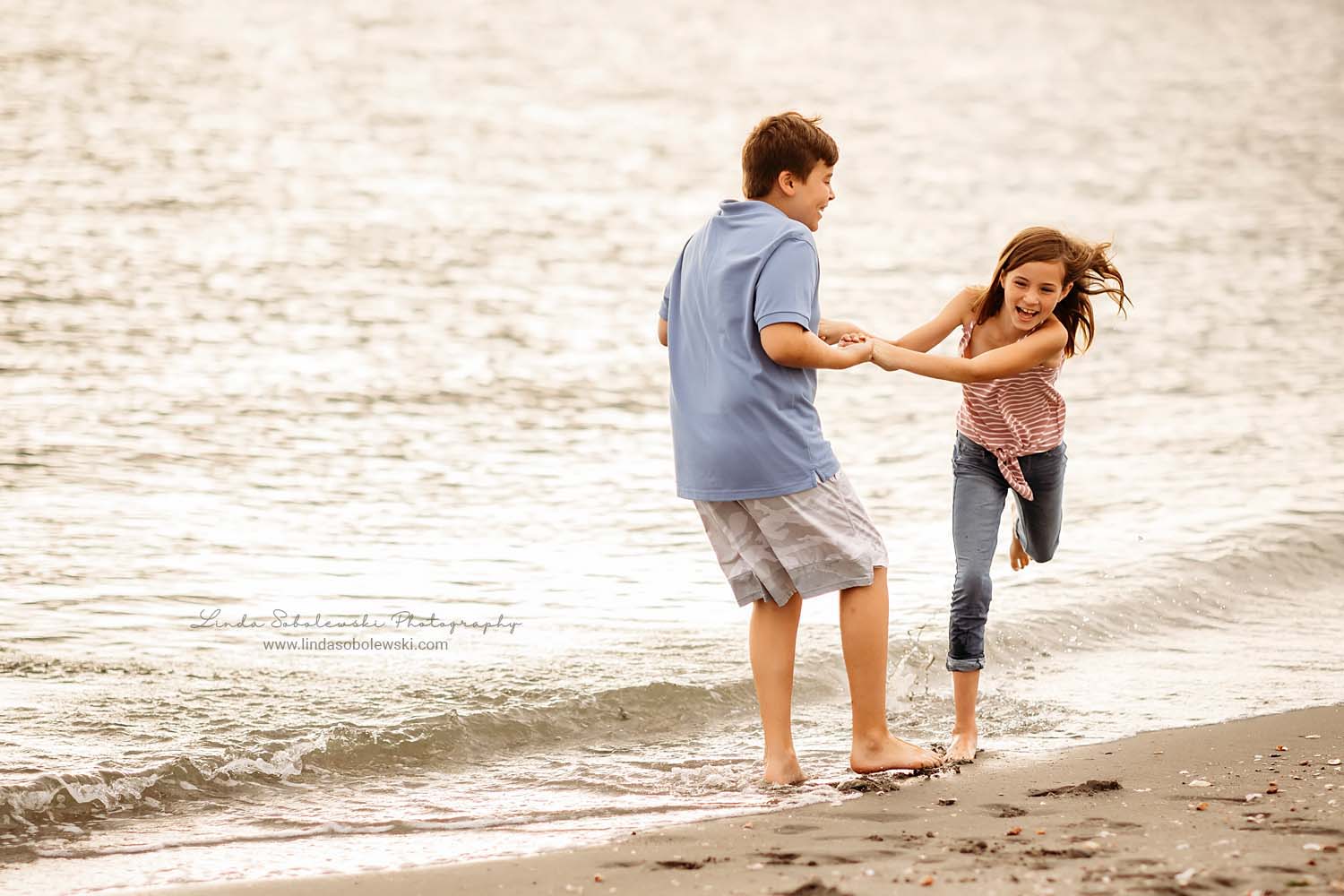 brother and sister playing at the beach, CT shoreline photo session