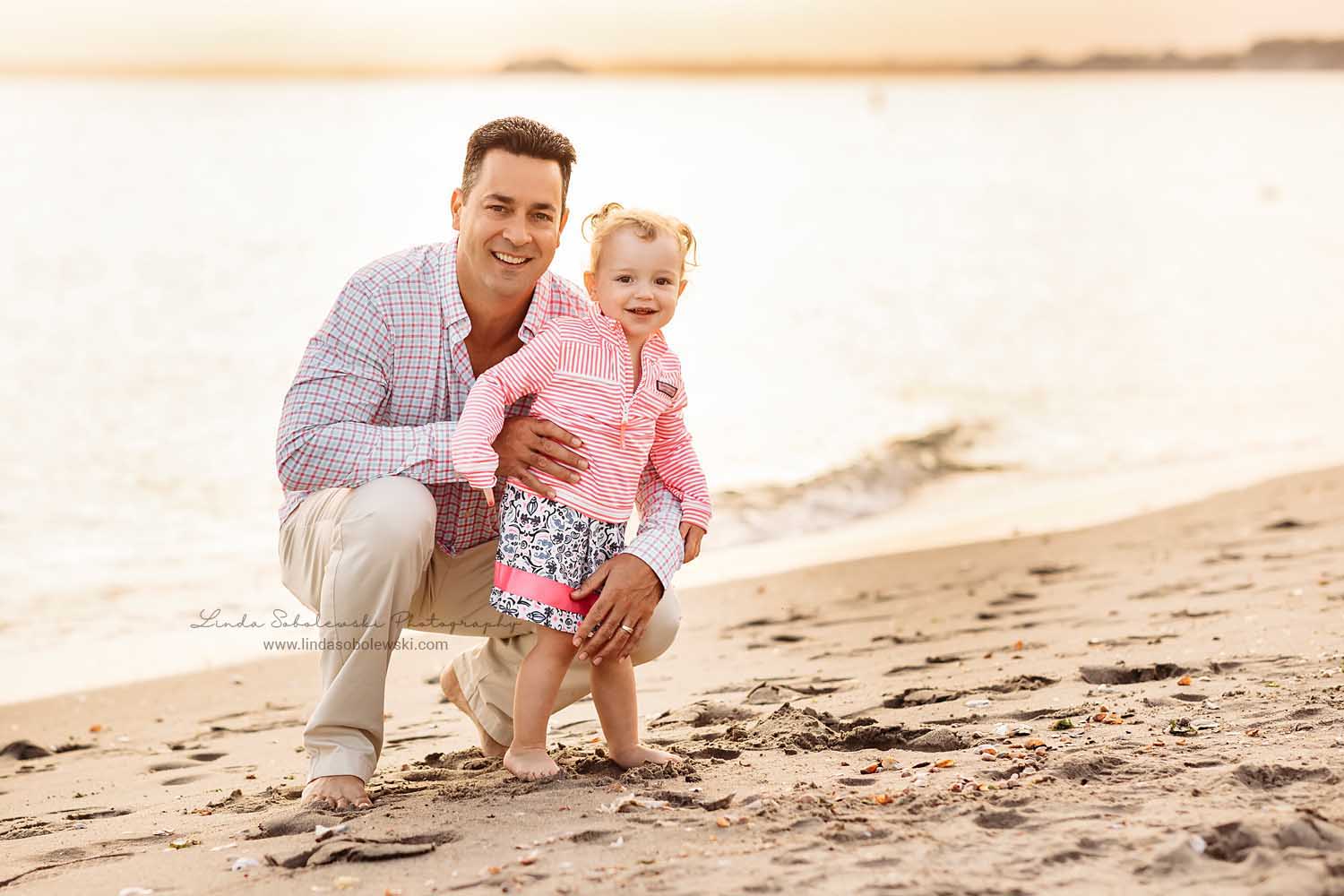 little girl and her dad playing together, photo session at the beach, Guilford, CT beach photographer