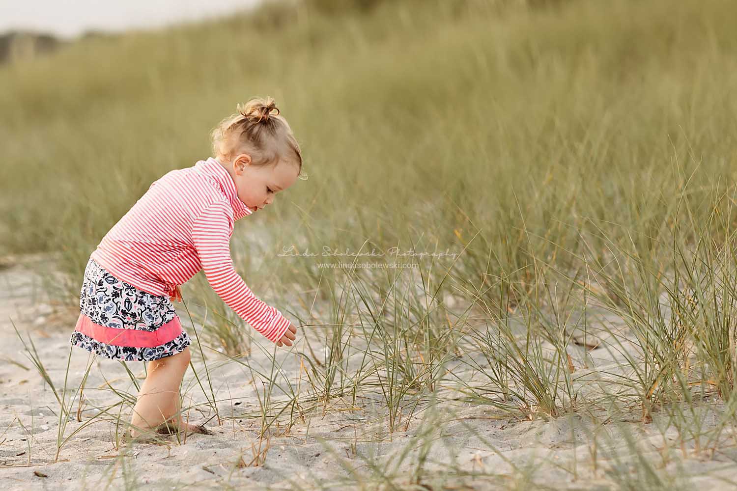little girl in pink shirt playing in the water, CT Shoreline Family photographer