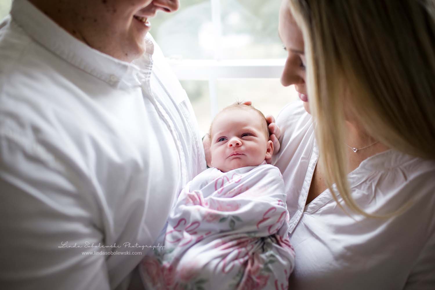 new parents holding their baby girl, Old Saybrook, CT newborn photographer