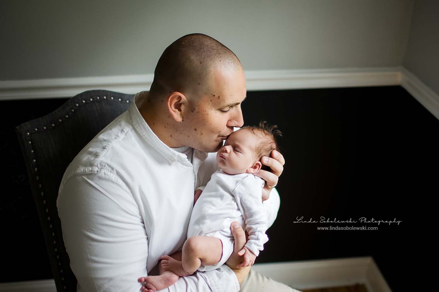 dad holding his newborn baby girl. Westbrook CT Lifestyle Newborn photographer