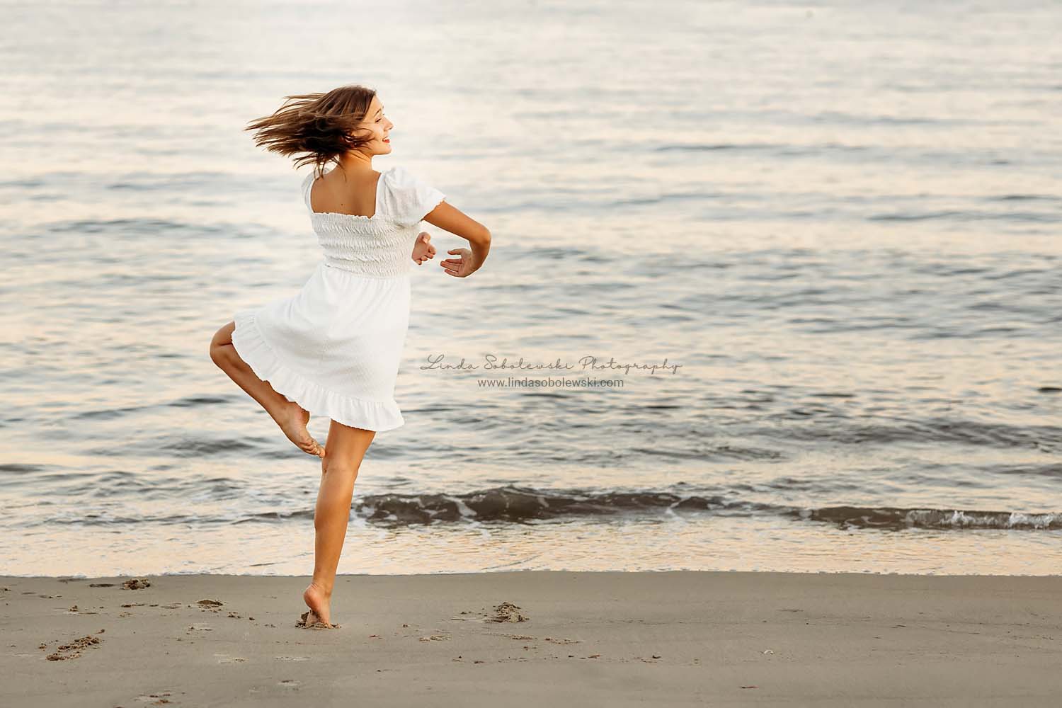 girl in white dress spinning around on the beach, CT Family photographer