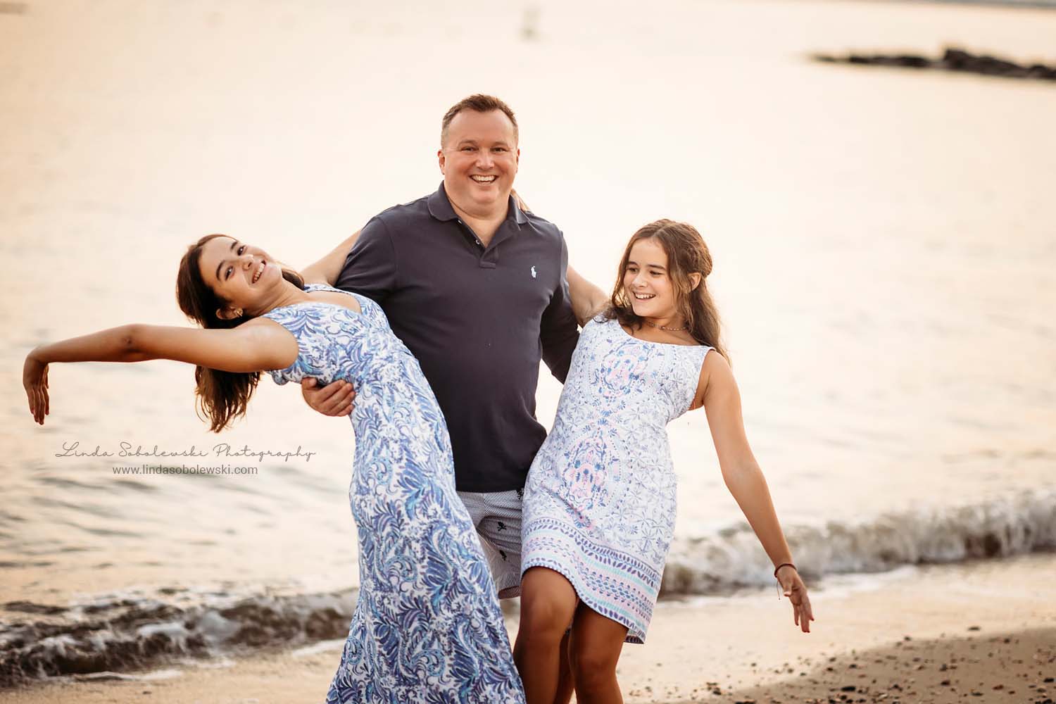 dad with his two daughters, photography session at the beach in Old Saybrook, CT