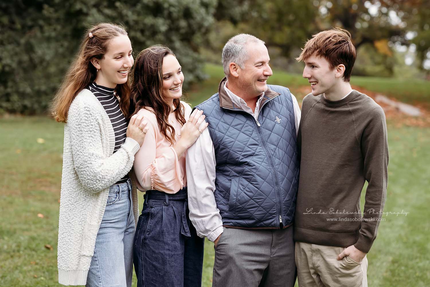father smiling at his four children, family photography session Chaffinch Island
